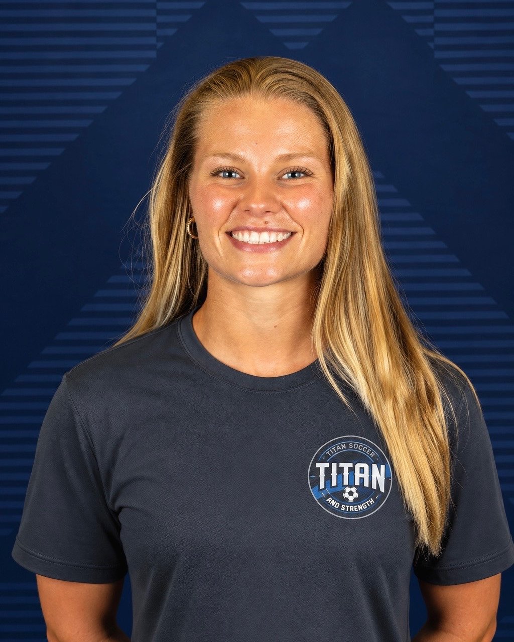 Coach Kiley Capling standing on a soccer field